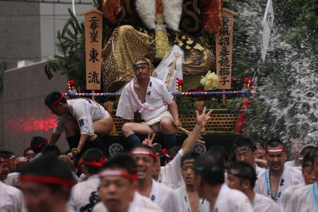 Exhausted Japanese men dragging their large floats through the streets of Fukuoka during Hakata Gion Yamakasa festival