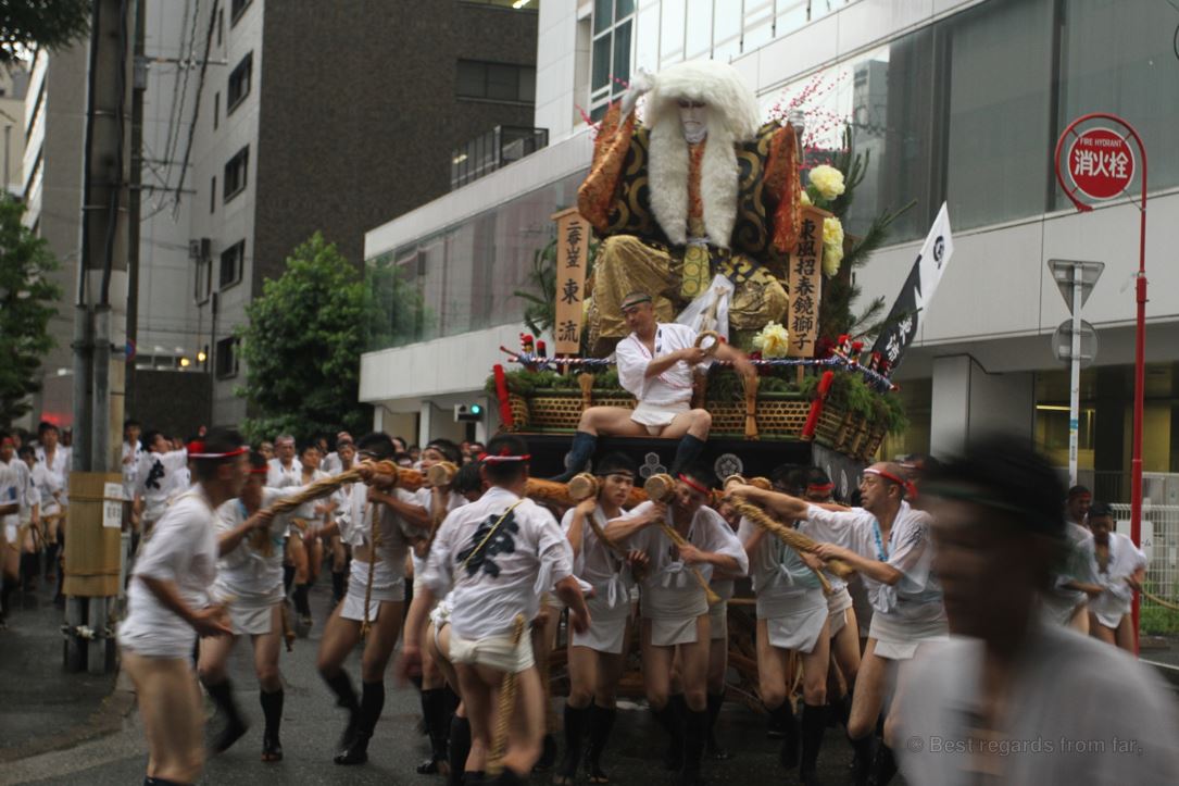 A large float dragged by Japanese men in traditional costumes through the streets of Fukuoka, Kyushu during the Hakata Gion Yamakasa festival
