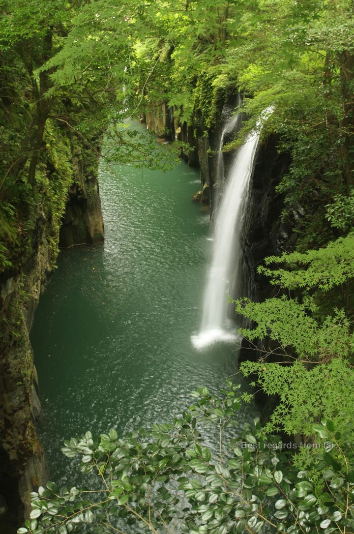 Spectacular waterfall of Takachiho falling into an emerald waterhole, Japan.