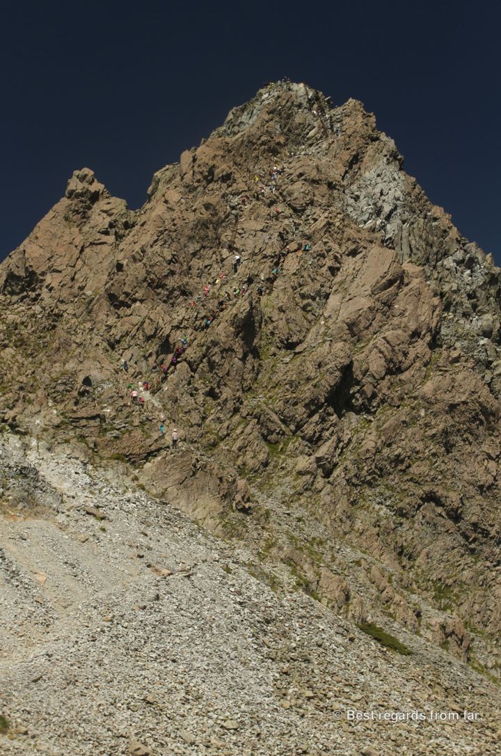 Tiny dots on the top of Yari-dake: hikers conquering the last stretch while hiking the Japanese Alps.