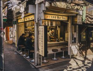 Two working men eating ramen noodles at a ramen-ya in Japan