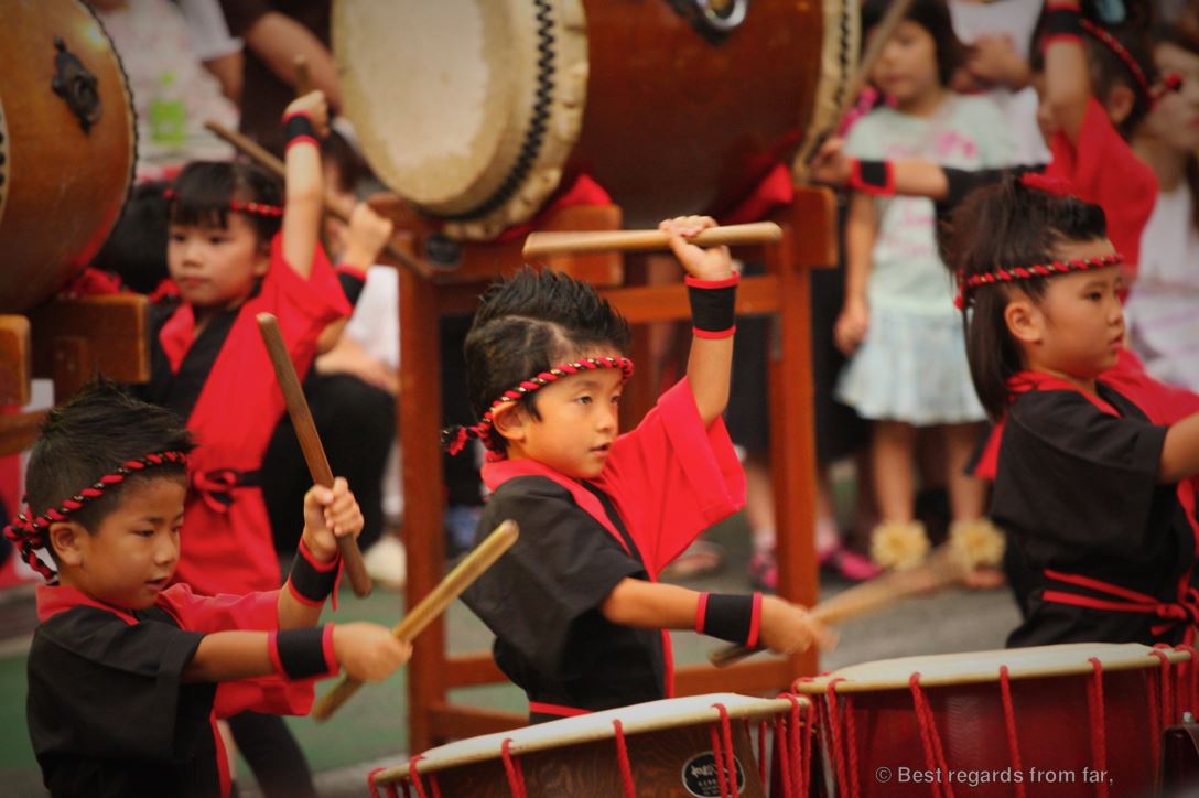 Young kids in traditional outfits proudly drumming at the Shikokuchuo summer festival, Shikoku, Japan