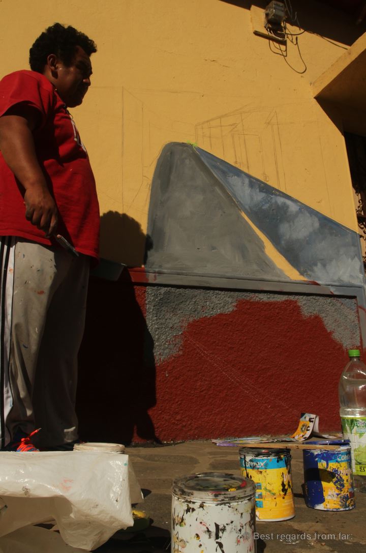 Mural artist Julio Cesar at work in Ataco, El Salvador