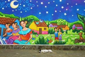 Sleepy dog in front of a colourful mural in Ataco, El Salvador