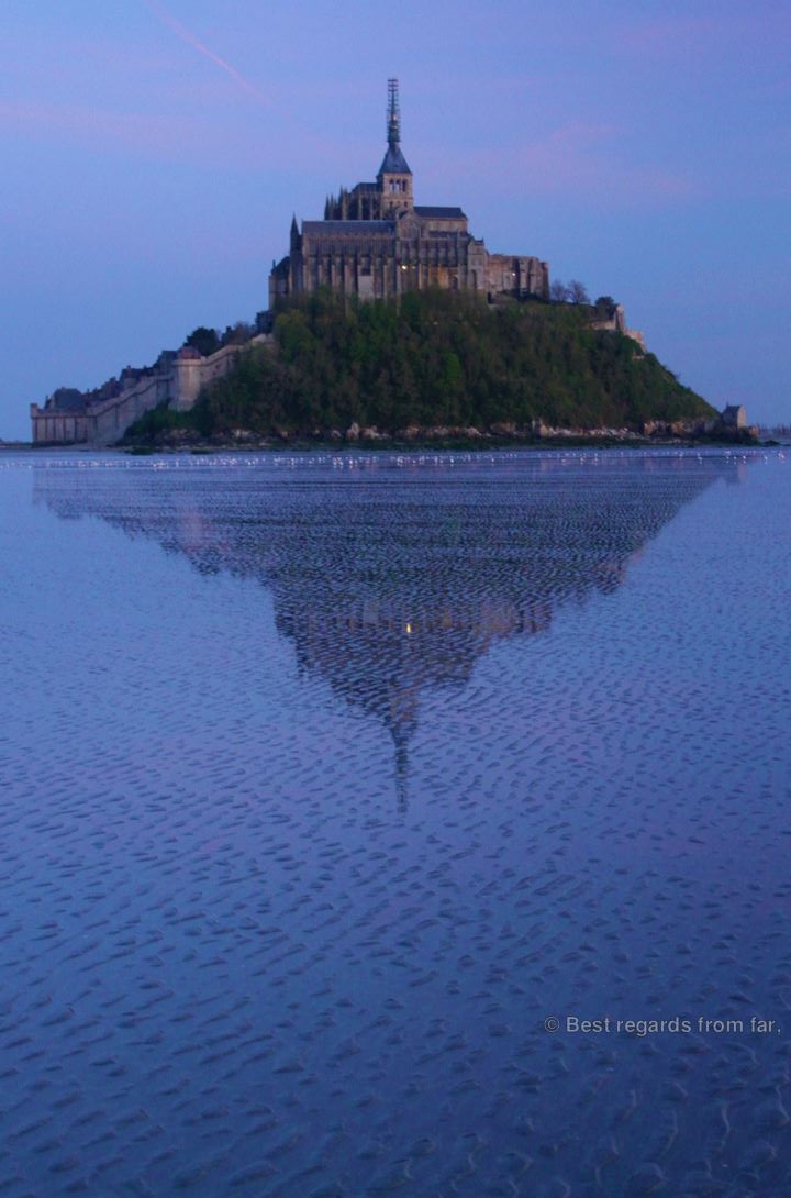 Mont Saint Michel and its reflection at dusk, France