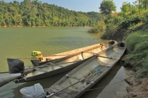 Fuel tanks recycled as bomb boats during the secret war in Laos Ban. Photo taken on the river in Thabak, Laos.