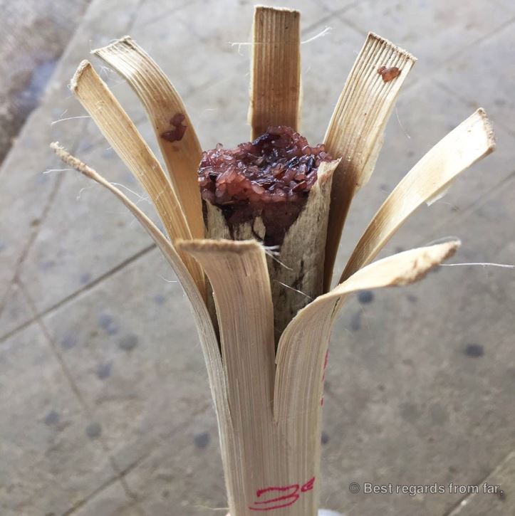 Red sticky rice in bamboo, ready for consumption.