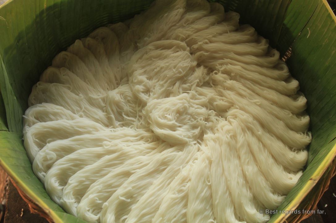 Circular pattern of fresh rice noodle portions in a large metal pot.
