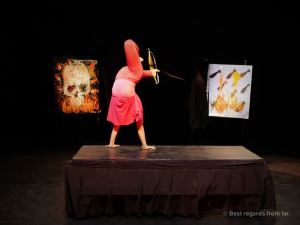 Circus artist using a bow and arrow with her feet, Phare the Cambodian Circus, Siem Reap, Cambodia.