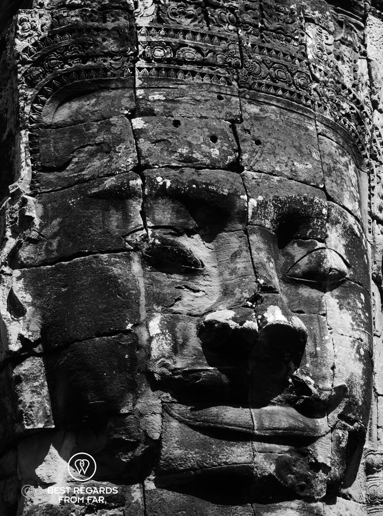 Close-up of a smiling king on the Bayon temple in Cambodia.
