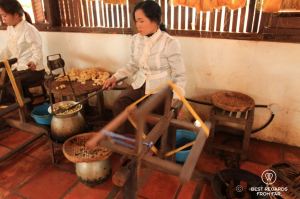 Women spinning silk as they boil cocoons.