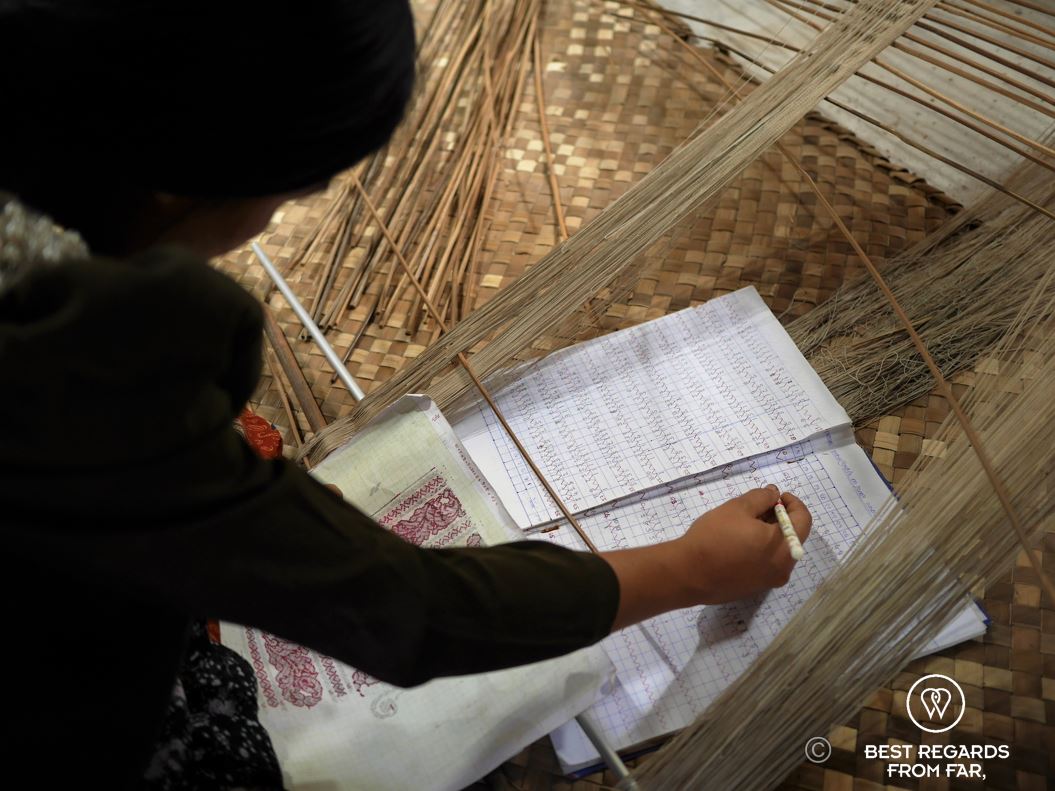 Woman creating a 3D scheme for a weaving loom.