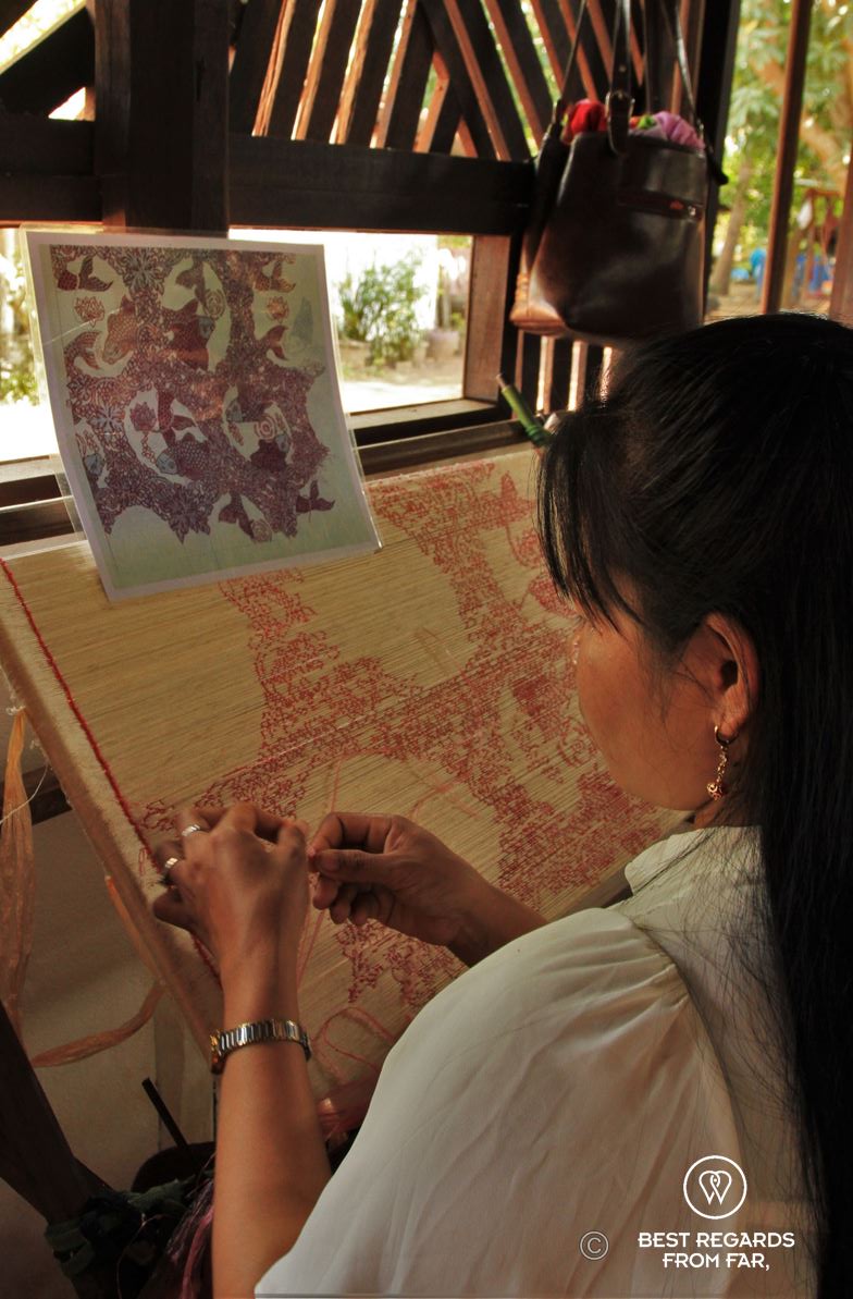 Woman wrapping threads of silk.