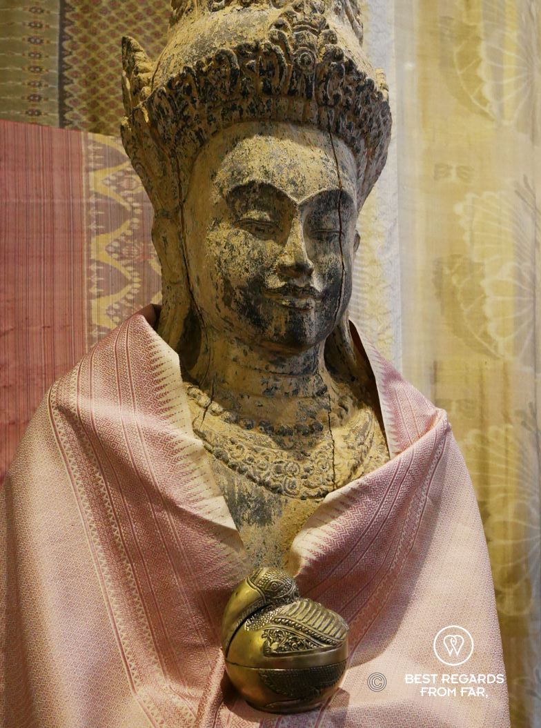 Statue wrapped in a delicate salmon-coloured silk cloak. 