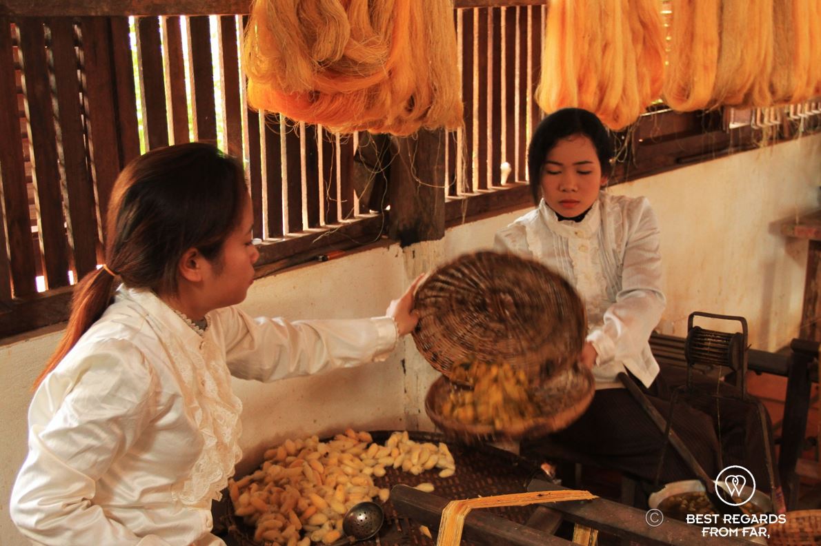 Two women spinning silk.
