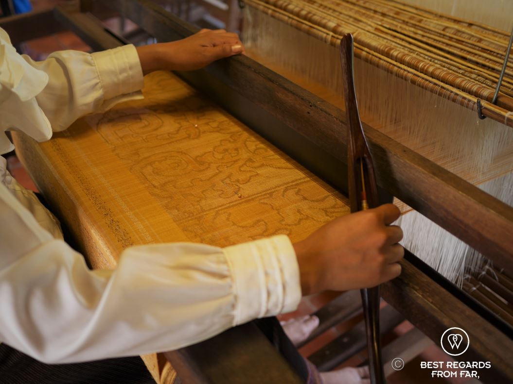 Weaving pre-dyed golden silk on the loom.