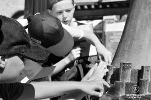 Children studying a bronze modal of the Carcassonne City.