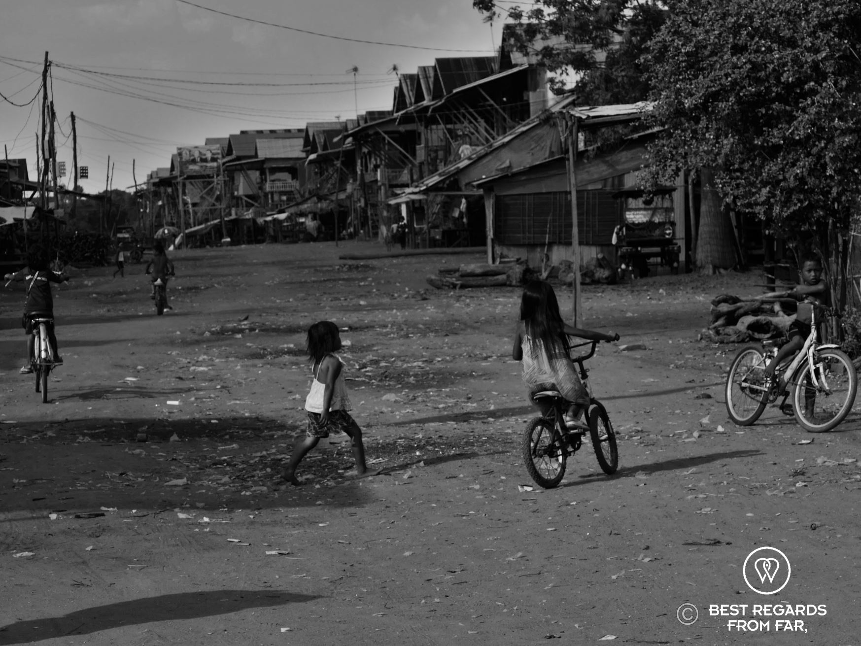 Children playing in the streets of a wooden floating village.