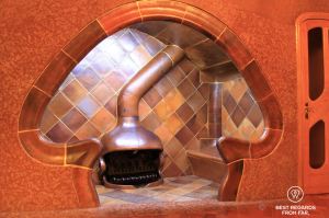 Fireplace inside a wall that is shaped by Gaudi as a mushroom in Casa Batllo.