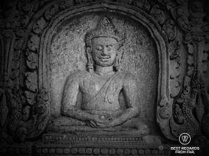 Stone scumpture of a Buddha holding a ball in his palm.