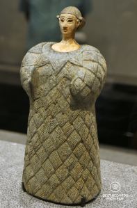 Small statue of a woman dressed in a woollen garment. Louvre Abu Dhabi, UAE