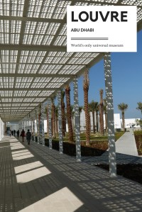 Modern entrance of the Louvre Abu Dhabi, palm trees and blue skies.