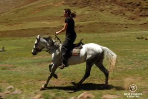 Writer Claire Lessiau horseback riding in Lesotho.