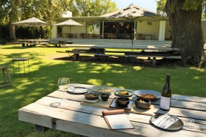 Delicious tapas set on a wooden table in the garden of the Chefs Warehouse Maison in Franschhoek, South Africa