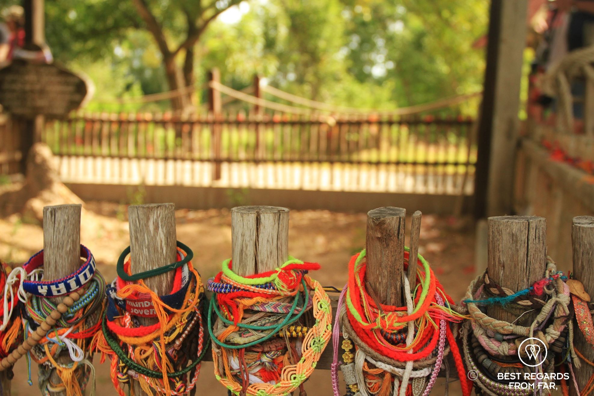 Colourful commemoration bracelets on a bamboo fence.