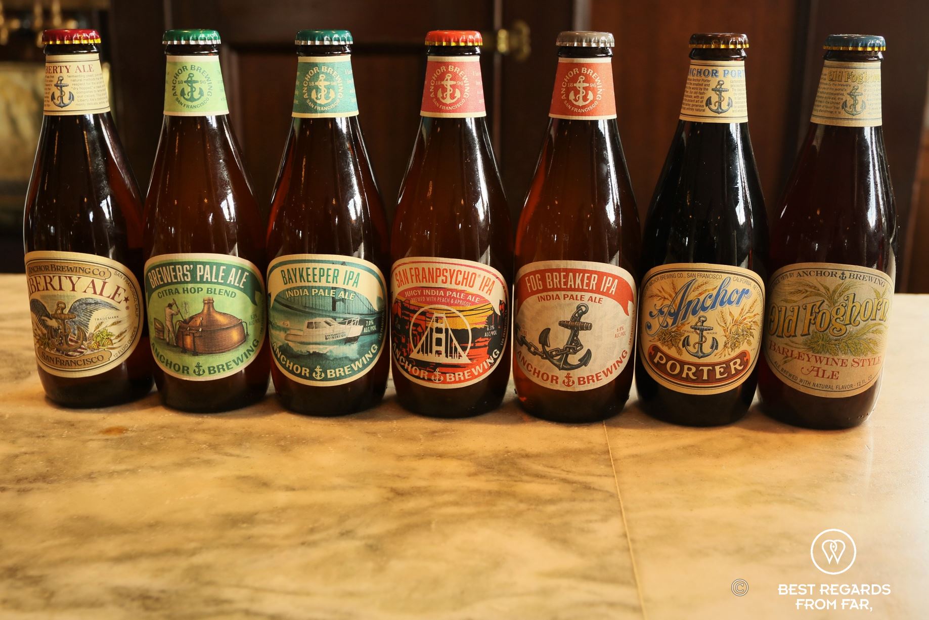 Line of different beer bottles brewed by Anchor Brewing Company.