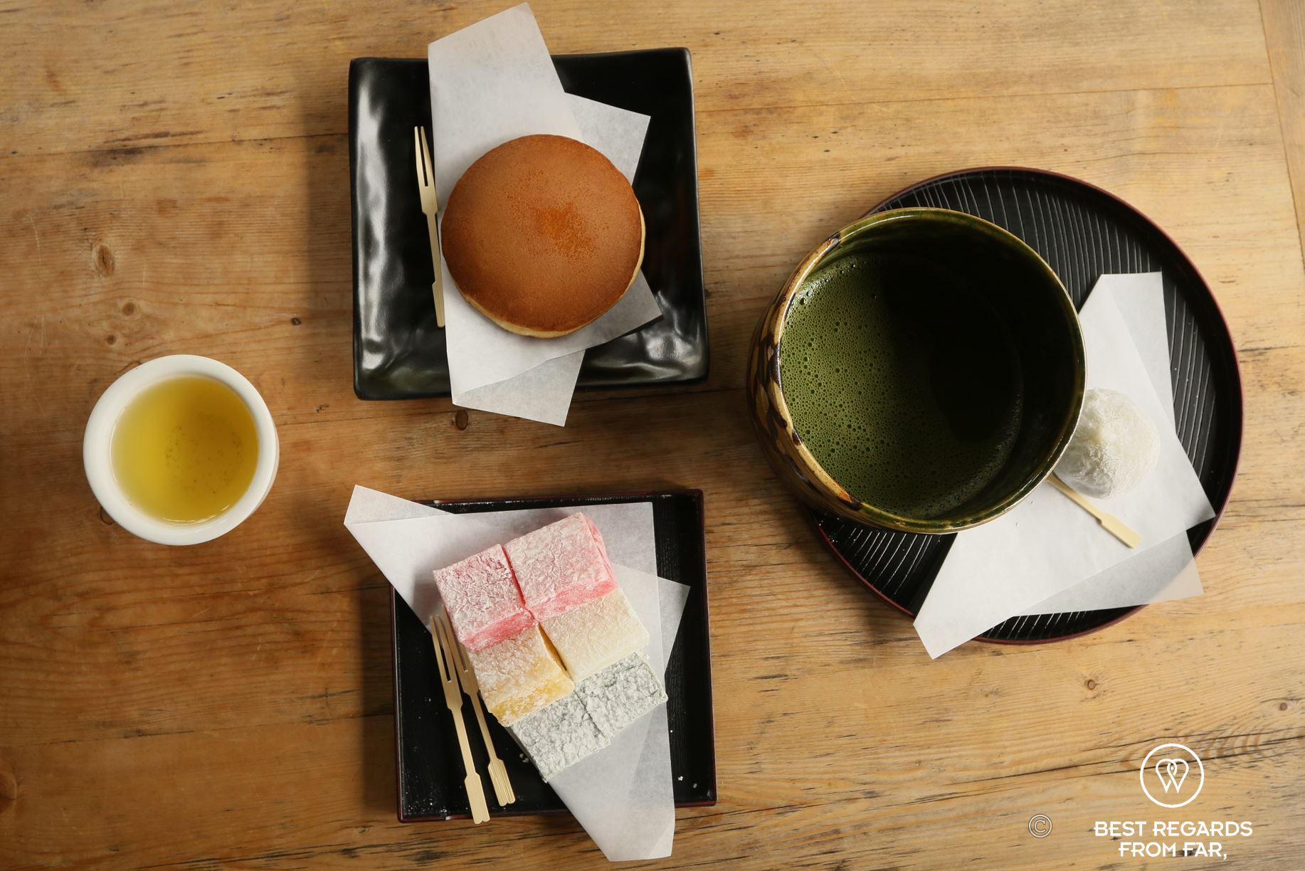 Sweets and macha green tea on wooden table.