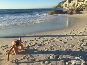 Woman writing in the sand on a sunny day