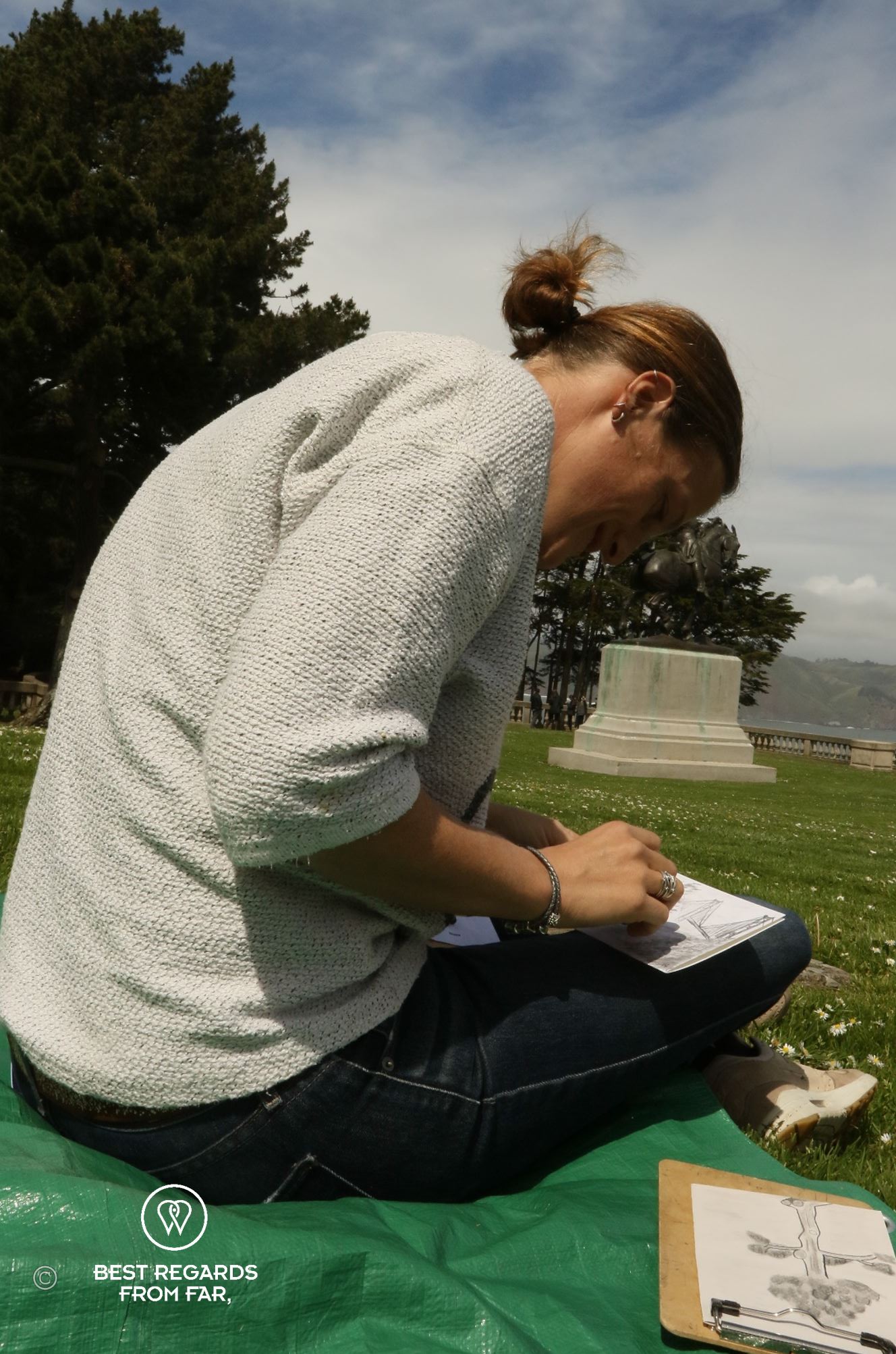 Woman making a drawing in a garden.