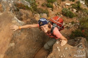 Woman scrambling up Table Mountain