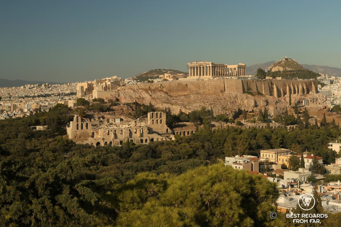 The Acropolis, old Greek buildings, green forest and blue skies, Athens.