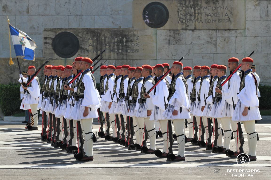 Military men dressed in traditional clothes and red barrets during the changing of the guards in Athens.