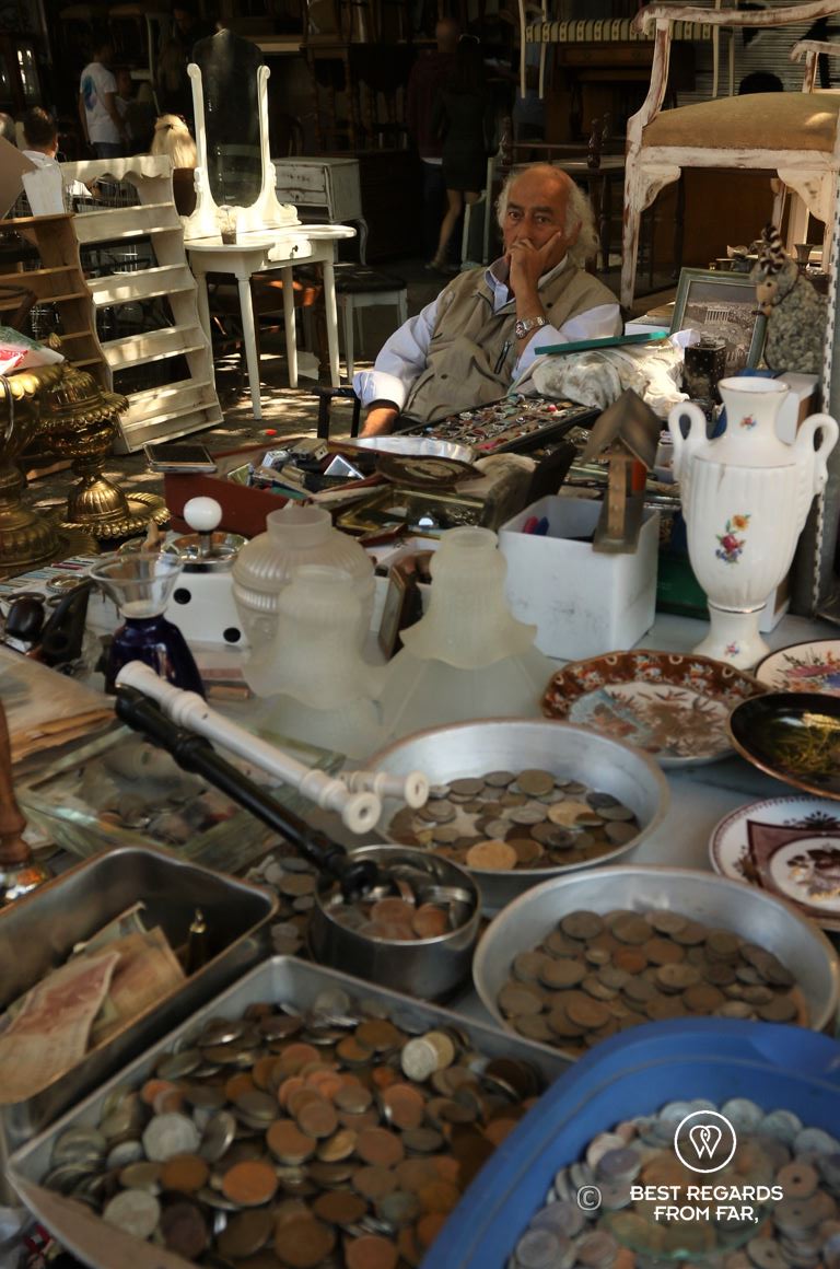 Man selling coins at the Monastiraky flea market, Athens, Greece