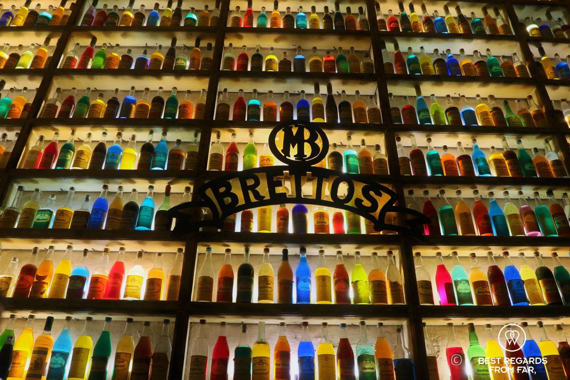 A wall of colourful bottles of local booze at the Brettos distillery, Plaka, Greece.