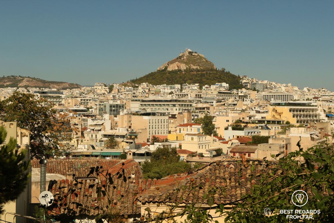 Blue skies, a mountain and houses at its feet.