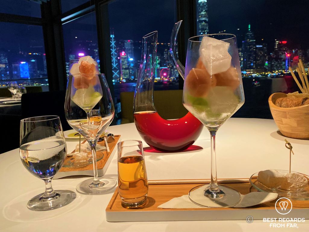Drinks and dinner with a view on the lit high-rise buildings of Hong Kong Island at Cucina restaurant, Kowloon, Hong Kong