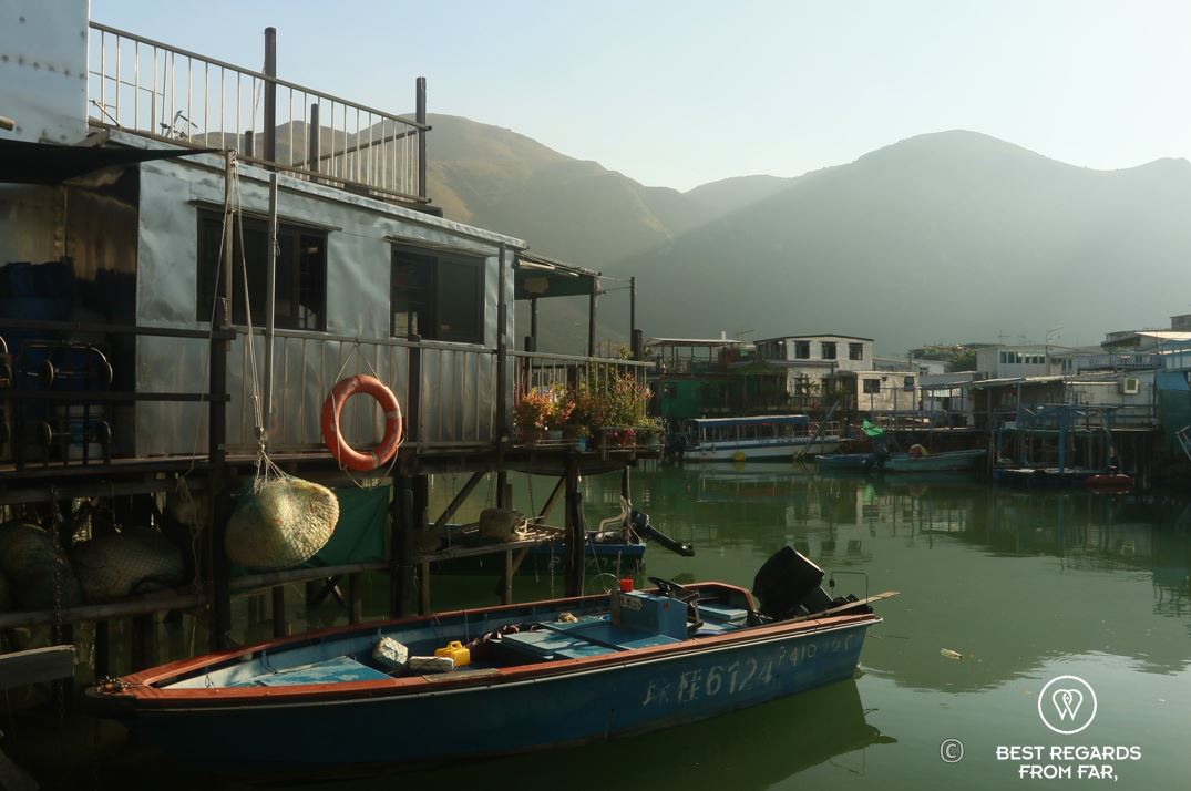 Blue boat and local houses on stilts, Tai O fishing village, Lantau Island, Hong Kong