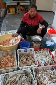 Local man selling dried fish in crates, Tai O fishing village, Lantau Island, Hong Kong