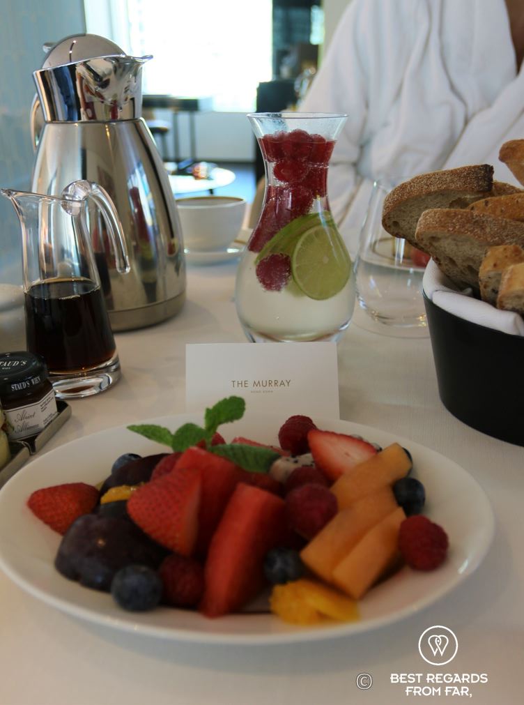Room service breakfast with healthy fruits and fresh bread at The Murray luxurious hotel in Hong Kong