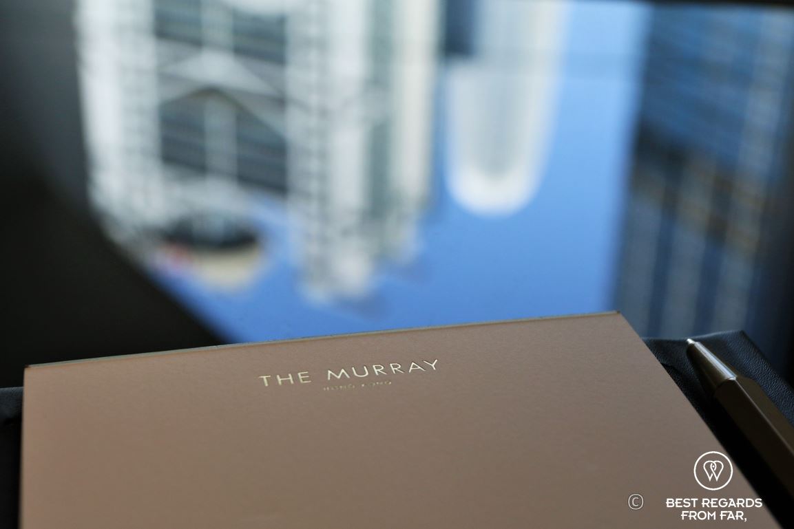 Note pad of the Murray hotel in a room in golden letters with the HSBC tower in the background