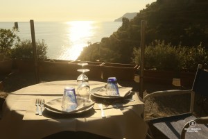 Dinner table set with a view at sunset in Italy