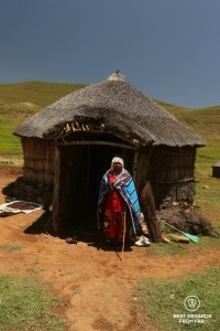 Traditional healer in front of her rondavel in Eastern Lesotho