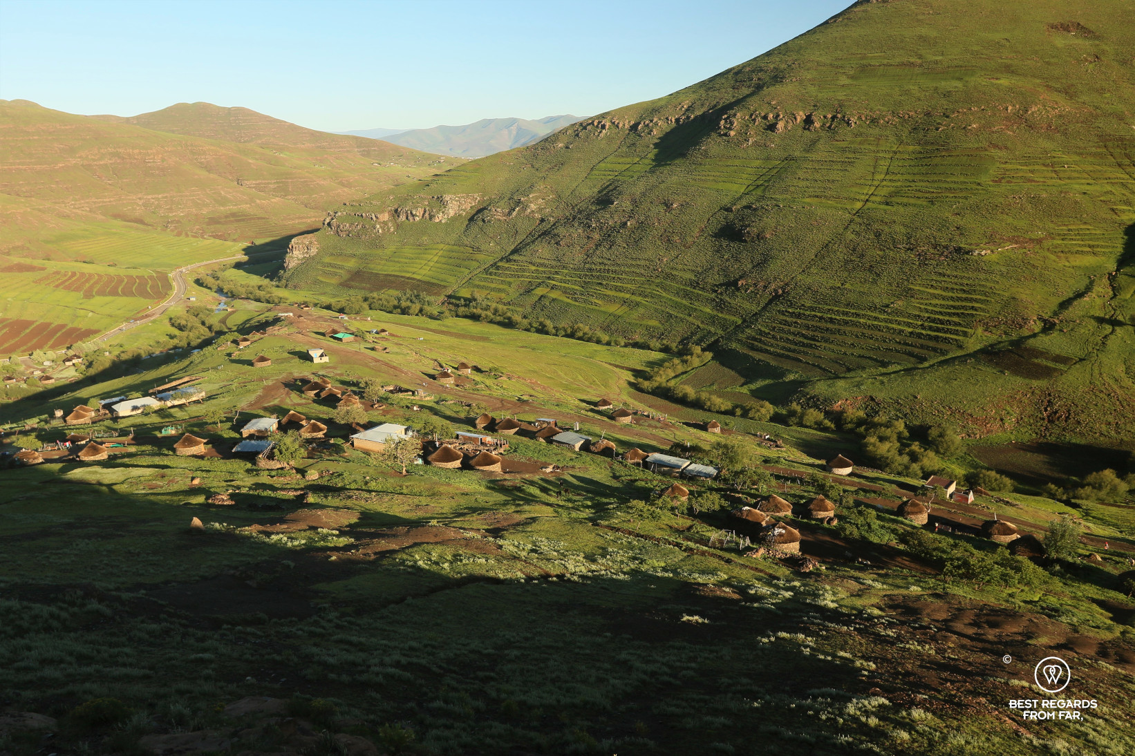Bird's eye view on the village of Makhapung in Eastern Lesotho with rondavels at sunrise