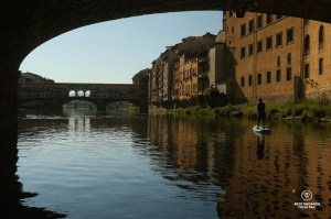 Stand up paddling the Arno River by the Ponte Vecchio in Florence, Italy