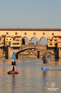Stand up paddling the Arno River by the Ponte Vecchio in Florence, Italy.