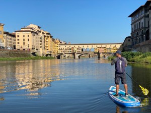 Stand up paddling the Arno River by the Ponte Vecchio in Florence, Italy.